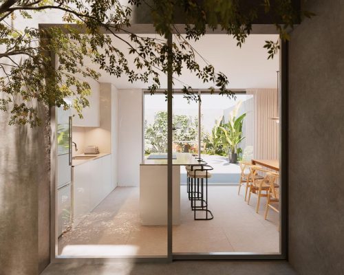 Cocina abierta en vivienda unifamiliar moderna con grandes ventanales y acceso al jardín en Valencia